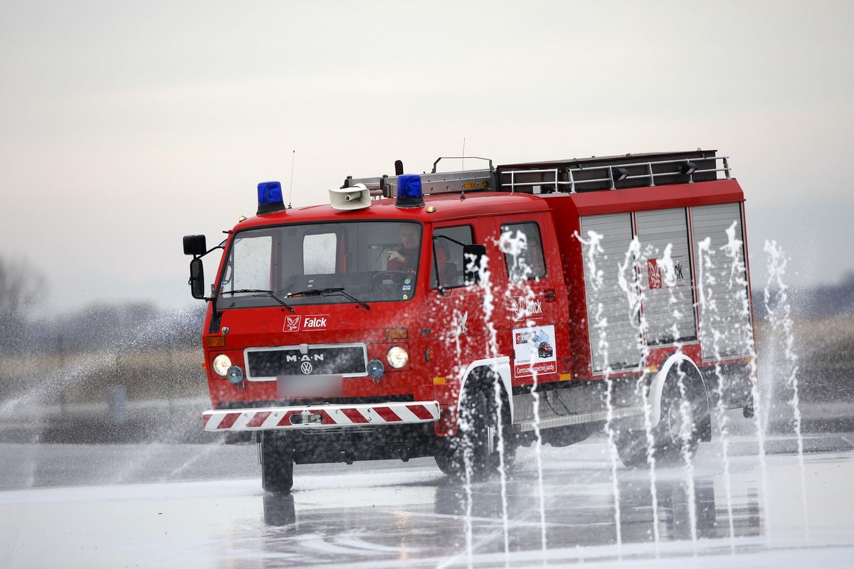 Hasičské auto vo vodných fontánach na polygóne